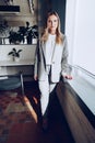 Portrait of a young businesswoman in formal outfit standing near window in office Royalty Free Stock Photo