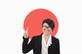 Portrait of young businesswoman gesturing peace sign over Japanese flag