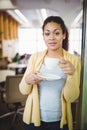 Portrait of young businesswoman having coffee at office Royalty Free Stock Photo