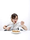 Portrait of young businesswoman ironing her shirt white having breakfast at table