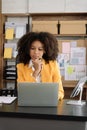 Portrait of a young businesswoman thinking work concept sitting at desk in the office Royalty Free Stock Photo