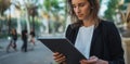 Portrait young businesswoman working with digital tablet and earphones at park., young girl using modern laptop typing text sms Royalty Free Stock Photo