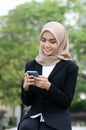 Portrait young businesswomen in black suit and hijab using smartphone Royalty Free Stock Photo