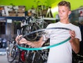 young buyer holding bicycle wheel