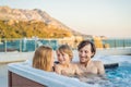 Portrait of young carefree happy smiling happy family relaxing at hot tub during enjoying happy traveling moment Royalty Free Stock Photo