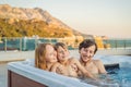 Portrait of young carefree happy smiling happy family relaxing at hot tub during enjoying happy traveling moment Royalty Free Stock Photo