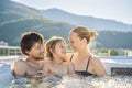 Portrait of young carefree happy smiling happy family relaxing at hot tub during enjoying happy traveling moment Royalty Free Stock Photo