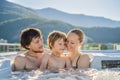 Portrait of young carefree happy smiling happy family relaxing at hot tub during enjoying happy traveling moment Royalty Free Stock Photo