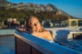 Portrait of young carefree happy smiling woman relaxing at hot tub during enjoying happy traveling moment vacation life Royalty Free Stock Photo