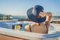 Portrait of young carefree happy smiling woman relaxing at hot tub during enjoying happy traveling moment vacation life Royalty Free Stock Photo