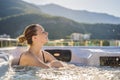 Portrait of young carefree happy smiling woman relaxing at hot tub during enjoying happy traveling moment vacation life Royalty Free Stock Photo