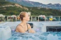 Portrait of young carefree happy smiling woman relaxing at hot tub during enjoying happy traveling moment vacation life Royalty Free Stock Photo