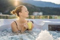 Portrait of young carefree happy smiling woman relaxing at hot tub during enjoying happy traveling moment vacation life Royalty Free Stock Photo