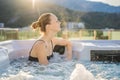 Portrait of young carefree happy smiling woman relaxing at hot tub during enjoying happy traveling moment vacation life Royalty Free Stock Photo