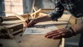 Portrait of a Young Carpenter Looking at a Blueprint and Starting to Assemble a Wooden Chair