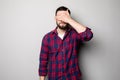 Portrait of a young casual man covering eyes with hand Royalty Free Stock Photo