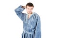 Portrait of young caucasian bearded man in blue bathrobe shows clueless emotion isolated on white background Royalty Free Stock Photo