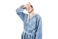 Portrait of young caucasian bearded man in blue bathrobe shows tired condition isolated on white background Royalty Free Stock Photo