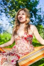 Portrait of Young Caucasian Blond Girl Relaxing In Hammock In Green Forest Outdoors Royalty Free Stock Photo