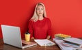 Portrait of young caucasian blonde female at work place Royalty Free Stock Photo