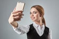 Portrait of young caucasian business woman in suit doing selfie on the phone. Royalty Free Stock Photo