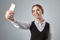 Portrait of young caucasian business woman in suit doing selfie on the phone. Royalty Free Stock Photo