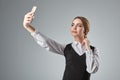 Portrait of young caucasian business woman in suit doing selfie on the phone. Royalty Free Stock Photo