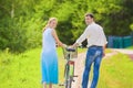 Portrait of Young Caucasian Couple Leading One Bicycle Together Royalty Free Stock Photo