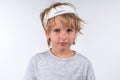 Portrait young caucasian cute boy blond hair with trauma injury and bandage head. Isolated on white background. Calm Royalty Free Stock Photo
