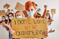 portrait of young caucasian female in protective face mask with cardboard in hands