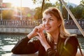 Portrait of young caucasian girl relaxing near water of river and promenade background in a sunny summer, spring or autumn day Royalty Free Stock Photo