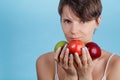 Portrait of young Caucasian girl who holds a red and green Apple in her hands as a concept of choosing the right food Royalty Free Stock Photo