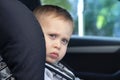 Little Boy Sitting on a Car Safety Seat Chair in a car Royalty Free Stock Photo