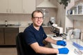 Portrait of young caucasian male scientist, medical worker, tech or graduate student works in modern biological laboratory Royalty Free Stock Photo