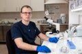 Portrait of young caucasian male scientist, medical worker, tech or graduate student works in modern biological laboratory Royalty Free Stock Photo