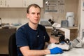 Portrait of young caucasian male scientist, medical worker, tech or graduate student works in modern biological laboratory Royalty Free Stock Photo