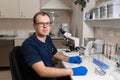 Portrait of young caucasian male scientist, medical worker, tech or graduate student works in modern biological laboratory Royalty Free Stock Photo