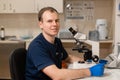 Portrait of young caucasian male scientist, medical worker, tech or graduate student works in modern biological laboratory Royalty Free Stock Photo