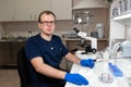 Portrait of young caucasian male scientist, medical worker, tech or graduate student works in modern biological laboratory Royalty Free Stock Photo