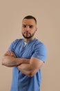 Portrait of young caucasian man doctor in blue uniform isolated, studio shoot Royalty Free Stock Photo