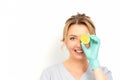 Portrait of young caucasian smiling female beautician covering eye with a lime slice wearing gloves over a white Royalty Free Stock Photo