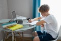 Portrait of young caucasian teen boy studying at home Royalty Free Stock Photo