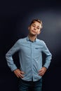 Portrait of a young caucasian teenage boy in a shirt. Black background Royalty Free Stock Photo