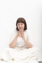 Portrait of young caucasian woman in bed with glass of water. Habit of drinking water in the morning Royalty Free Stock Photo