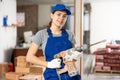 Portrait of woman engineer holding electric hammer