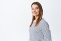 Portrait of young caucasian woman with fair hair and white smile, turn head at camera and looking friendly and natural Royalty Free Stock Photo