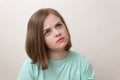 Portrait of young caucasian woman girl with questioning, puzzled, confused expression, thinking or remembering something Royalty Free Stock Photo
