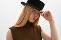 Portrait of young caucasian woman holding dark hat Royalty Free Stock Photo