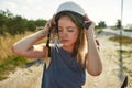 Portrait of young caucasian woman putting on helmet Royalty Free Stock Photo