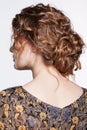 Portrait of a young caucasian woman with wavy hair  in vintage retro dress from back side Royalty Free Stock Photo